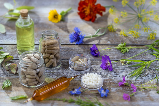 alternative herbal medicine. herbal vitamin on ols wooden board background.