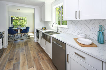 Fototapeta na wymiar Remodeled kitchen with pure white cabinets.