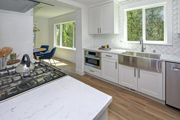 Remodeled kitchen with pure white cabinets.