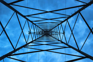 Inside high voltage power pole against evening sky