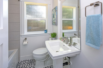 White bathroom design with pedestal sink.