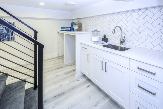 Basement laundry room interior with a sink.