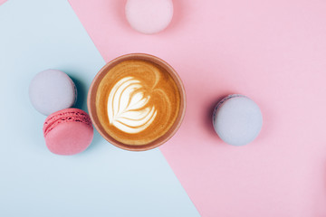 Paper cup of coffee to go with macaron