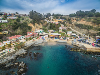 Fototapeta premium Aerial front view of a cove village in the sea