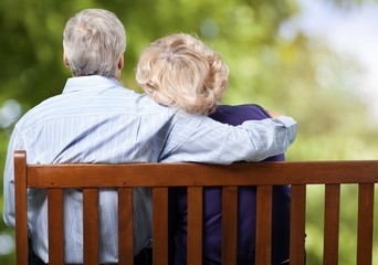 Portrait of happy senior couple in green