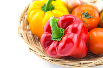Organic vegetables in the wicker basket on white background