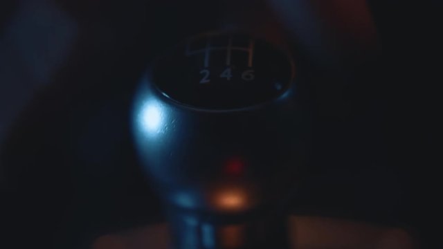 Car Interior - Shifting / Changing Gear Stick in Manual Car, Close Up, Night Time with Street Lights
