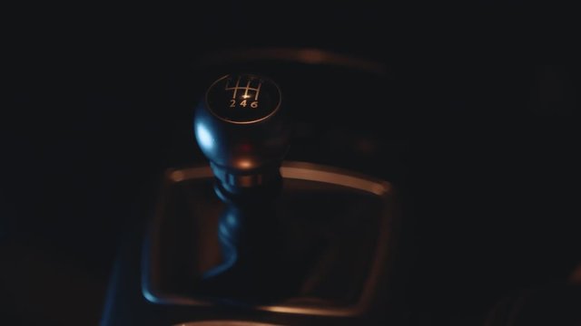 Car Interior - Shifting / Changing Gear Stick in Manual Car, Close Up, Night Time with Street Lights