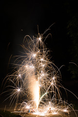 Ground spark shower fireworks or firecrackers in home driveway at night © Brett