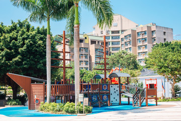 Playground and tropical palm trees at Stanley in Hong Kong - obrazy, fototapety, plakaty
