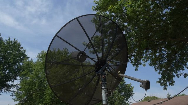 A vintage satellite dish changing positions