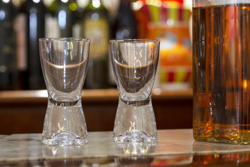 Two empty glasses and full wisky bottle