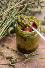 Ajika or adjika green chilly pepper paste or spicy dip. Green Megrelian ajika with coriander leaves. Traditional Georgian or Armenian relish used to flavor food.