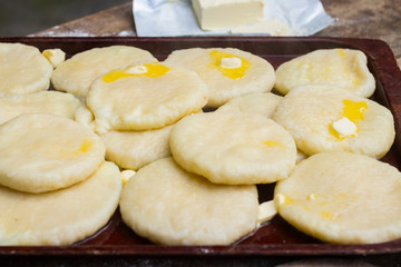 Cooked khachapuri bread with suluguni cheese and butter. Georgian traditional food.