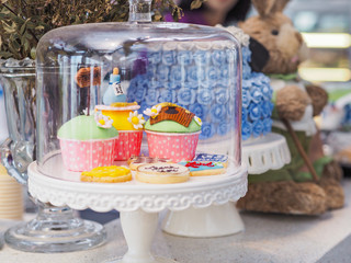 colorful fancy cupcake on white cakestand