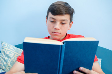 Teenage boy reading a book