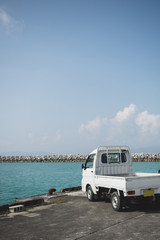 Small Truck Parked Beside Ocean