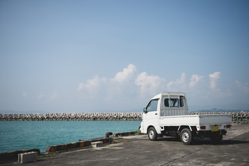 Small Truck Parked Beside Ocean
