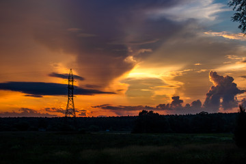 Bright beautiful sunset on the background of power lines