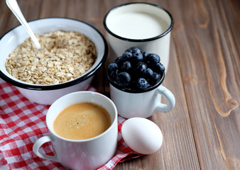 A healthy breakfast - Oatmeal porridge, boiled egg, milk, fresh berries and coffee. A great start to a new day.