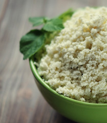 Fresh cottage cheese in a  bowl on a wooden table.