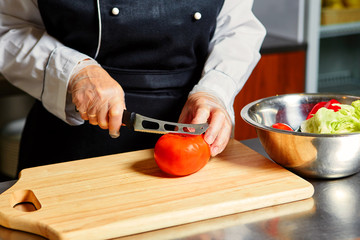 Cutting Tomato on Chopping Board,Closeup.