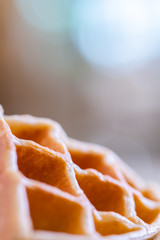 woman hands prepare waffle for serving process.waffle made from dough and batter.tasty dessert sweets waffle served on daylight in cafe bokeh background.waffle with strawberry on black plate.