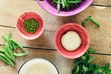 Top view Raw ingredients cooking vegetable risotto green peas mint goat cheese wooden rustic table Healthy food concept