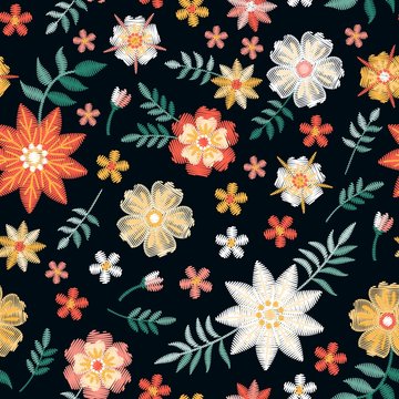 Beautiful seamless pattern with red, yellow and white embroidery flowers on black background. Embroidered print for fabric, textile, wallpaper. Fashion design. Vector illustration.