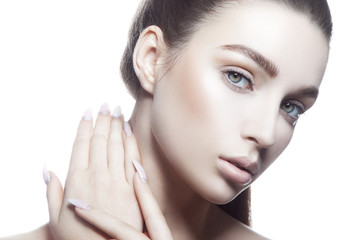 Beauty face of model girl with nude make-up, clean skin. Hand with stiletto nails. Skincare woman...