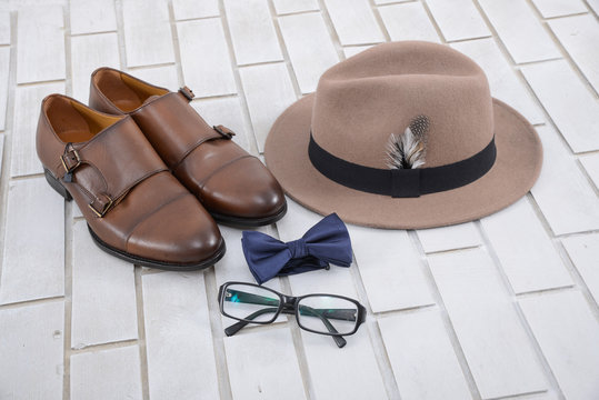 Set of mans fashion and accessories on white brick wall