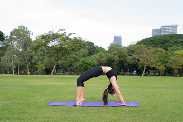 Fototapeta premium Woman Exercise Yoga In Park Ready For Healthy Lifestyle In Nature