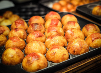 Takoyaki are cooked on the hot stove. Japanese street food.