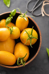 Yellow Tomatoes as high detailed close-up shot on wooden table selective focus.