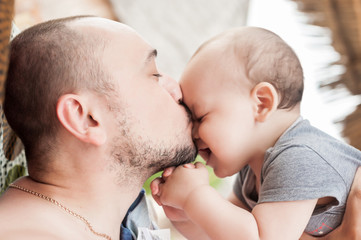 Father and son spend time together. Parent-child relationship. Dad and kid play and hug. Happy family in the sun