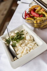 Bowl of peppers and a bowl of cheese.