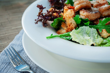 Seafood Caesar Salad with Shrimps, Salad Leaf, Croutons, Cherry Tomato and Parmesan Cheese. Served with fork