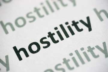 word hostility printed on paper macro
