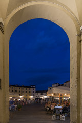 Arched entrance to the Piazza dell'Anfiteatro in the blue hour, Lucca, Tuscany, Italy