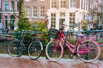 Fototapeta na wymiar Bicycles lining a bridge over the canals of Amsterdam