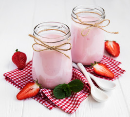 Jars with strawberry yogurt