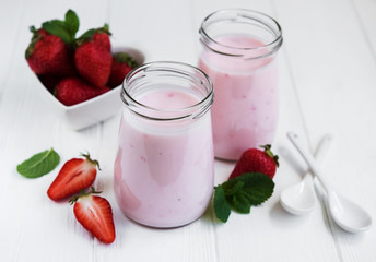 Jars with strawberry yogurt