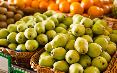 appetizing pears on counter in market