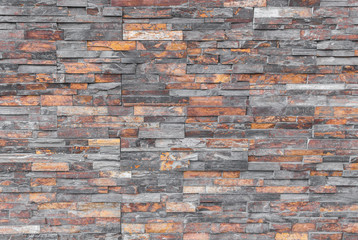 Modern irregular multi-color brick wall background.