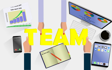 Team work concept. Top view on hands with letters TEAM above desk with laptop,mobile, tablet and other business accessories Modern business workplace
