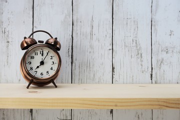 vintage alarm clock with space for copy on wooden background