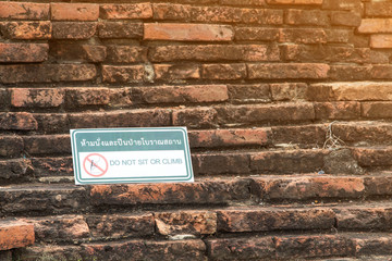 Sign board is do not of ancient ruin statue in Historical Park of Ayutthaya