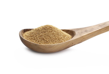 Amaranth seeds in wooden spoon isolated on white background