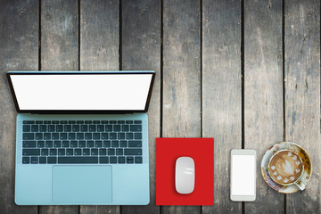 Laptop on Vintage Wooden desktop in modern office with accessories - top view on desk from above.