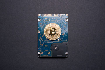 Gold bitcoin on a hard disk drive.